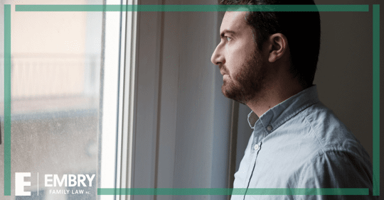 man looking out window