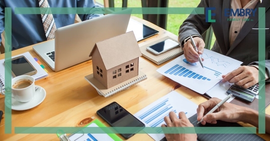 little house and documents at business table