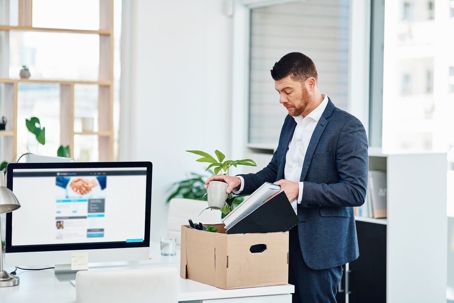 man packing up his belongs at work