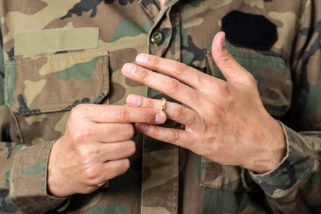 servicemember removing his wedding ring