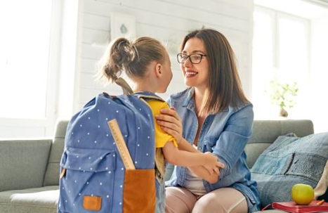 mother getting daughter ready for school